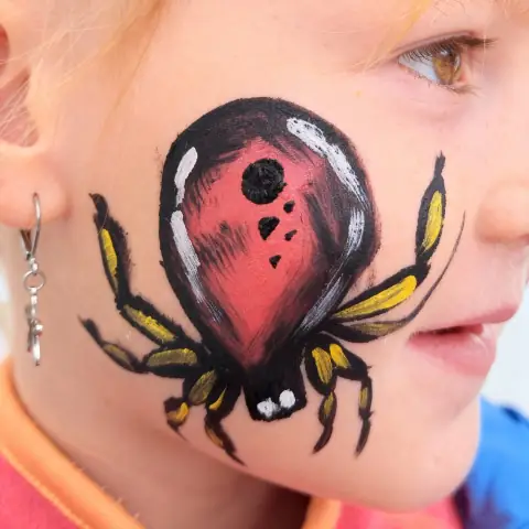 Ladybird design painted on a cheek
