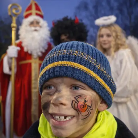 Winter face painting on a child's cheek