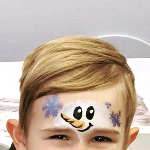 Snowman painted on a child's forehead